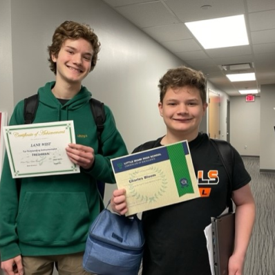 students smiling holding certificate